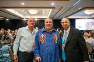Colorful group photo of conference attendees at Toms Photo Gallery, showcasing diversity and professional networking.